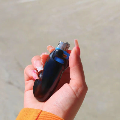 Schwarze Chromglanz Feuerzeughülle mit Feuerzeug in der Hand